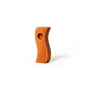 Cherry wood pipe shaped like a tilde or wave against a white background